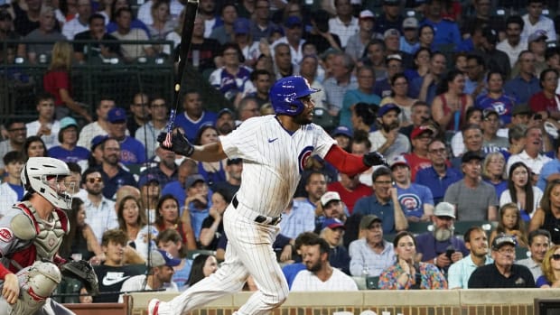 Aug 1, 2023; Chicago, Illinois, USA; Chicago Cubs first baseman Jeimer Candelario (9) hits an infield single against the Cincinnati Reds during the third inning at Wrigley Field. Mandatory Credit: David Banks-USA TODAY Sports  